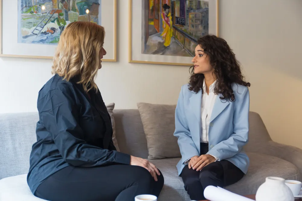 Two adults in a calm one-to-one conversation during an ADHD therapy session in London
